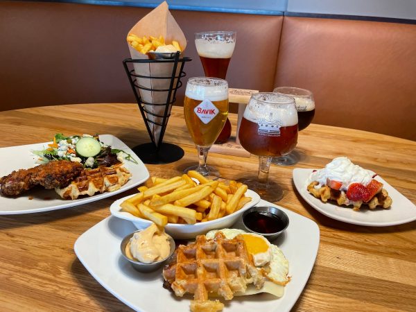 Table at Taste of Belgium in Cincinnati with Belgian beers, fried chicken, fries, and classic Belgian dishes.
