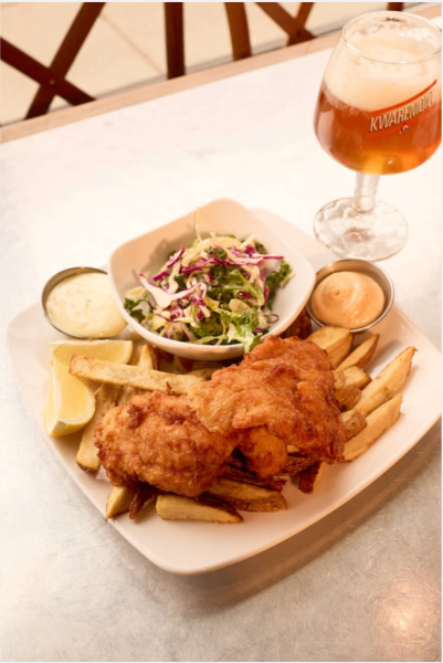 Plate of crispy fried chicken, fries, side salad, and a cold beer served at Taste of Belgium in Over-the-Rhine, Cincinnati.