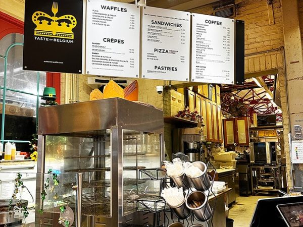 Belgian-style dining space at Taste of Belgium Findlay Market with warm lighting and wood furnishings.
