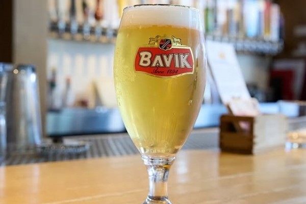 Bavik Super Pils Belgian beer served on the bar at Taste of Belgium in Cincinnati, highlighting local craft beer culture.