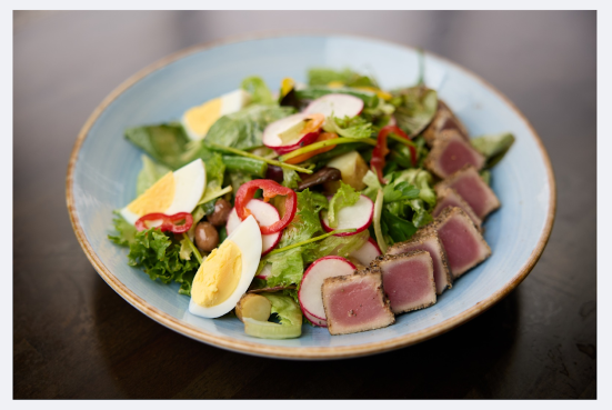 Seared tuna Niçoise-style salad with hard-boiled eggs, olives, and greens served during Belgian brunch in Cincinnati.