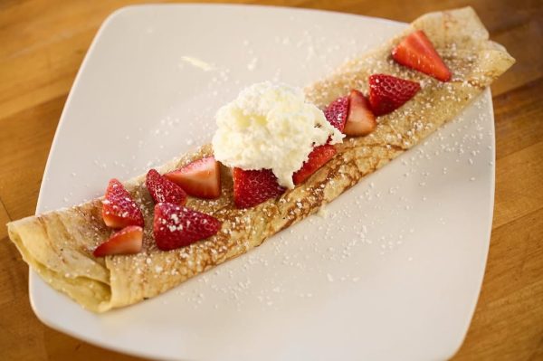 A plate of Taste of Belgium’s strawberry and crème crêpe, served with a sweet and creamy filling.