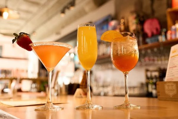 Summer Love martini, Oasis mimosa, and Coastal Spritz cocktail trio served at Taste of Belgium, showcasing creative Belgian beer drinks.